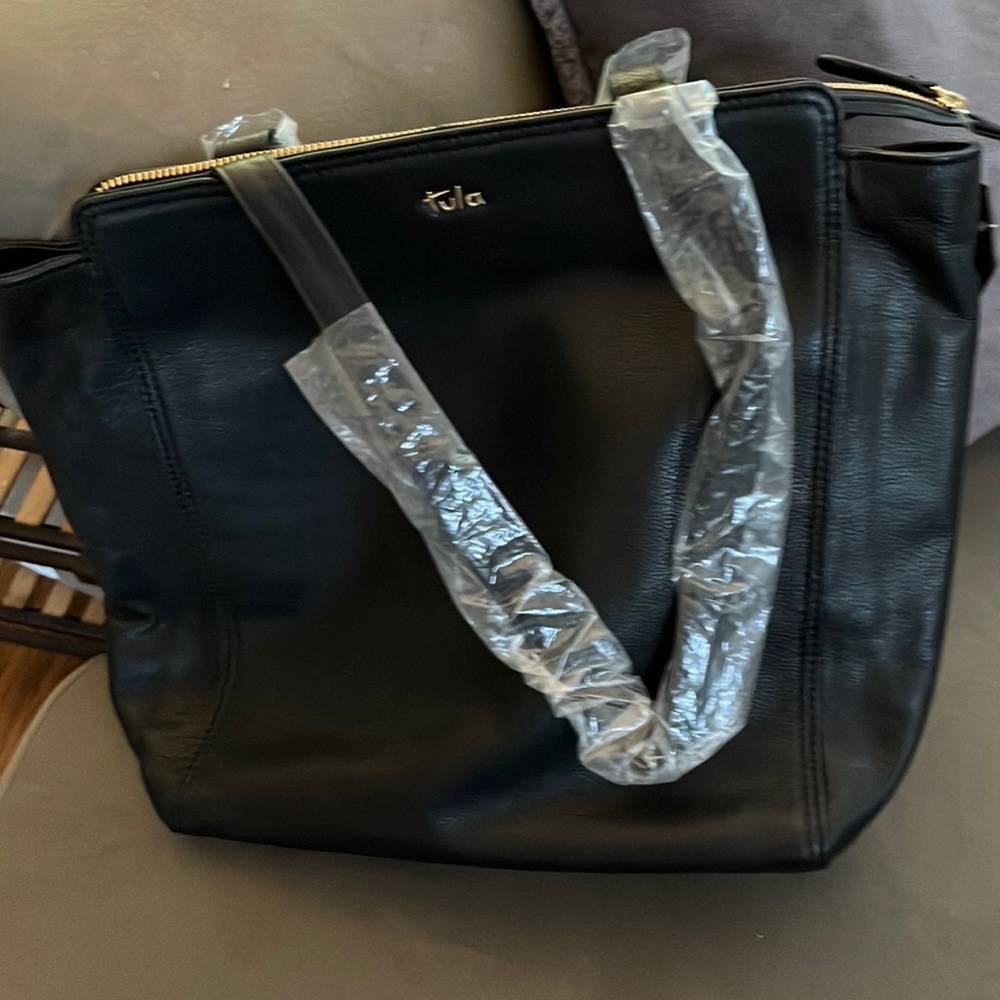 Black NWT Tula bag.  Outside pocket w zipper. Inside zipper & phone holder